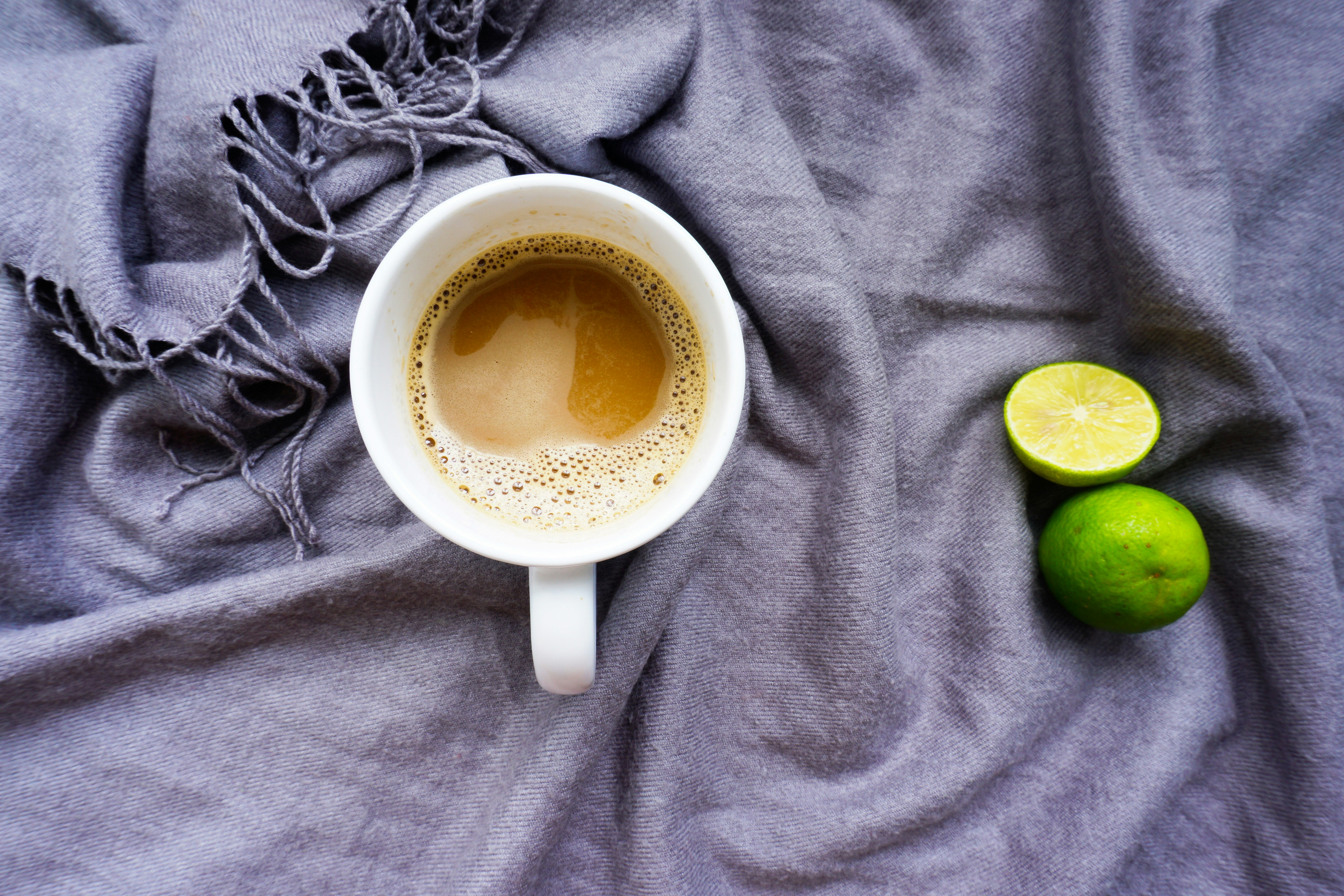 Flatlay with cup of coffee and lemons in scarf