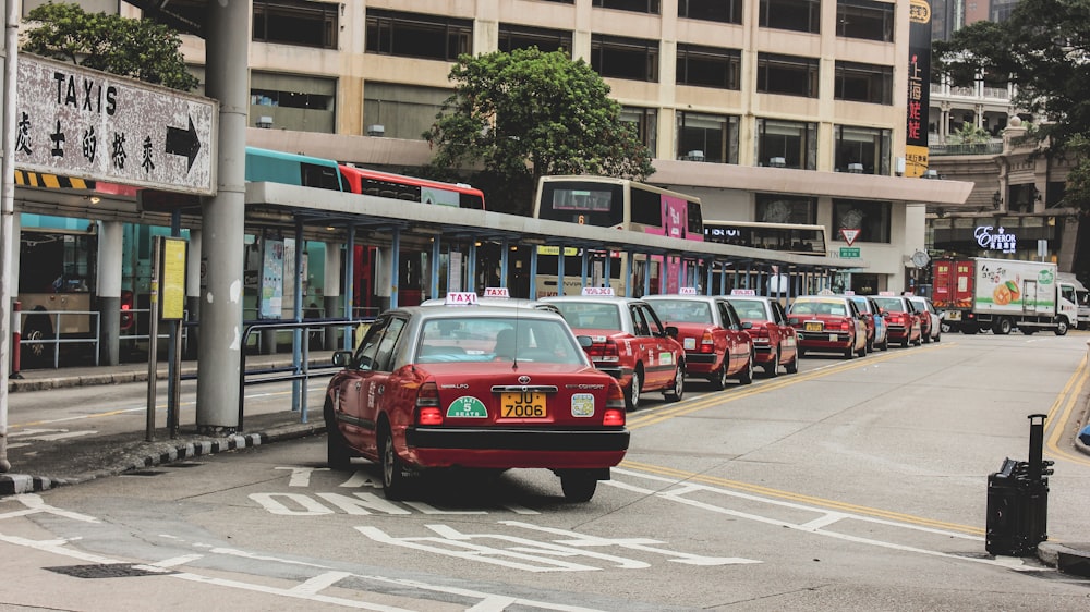 red and black cars on road near building during daytime