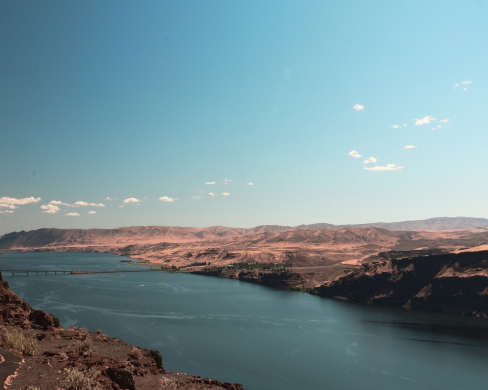 brown mountains near body of water during daytime