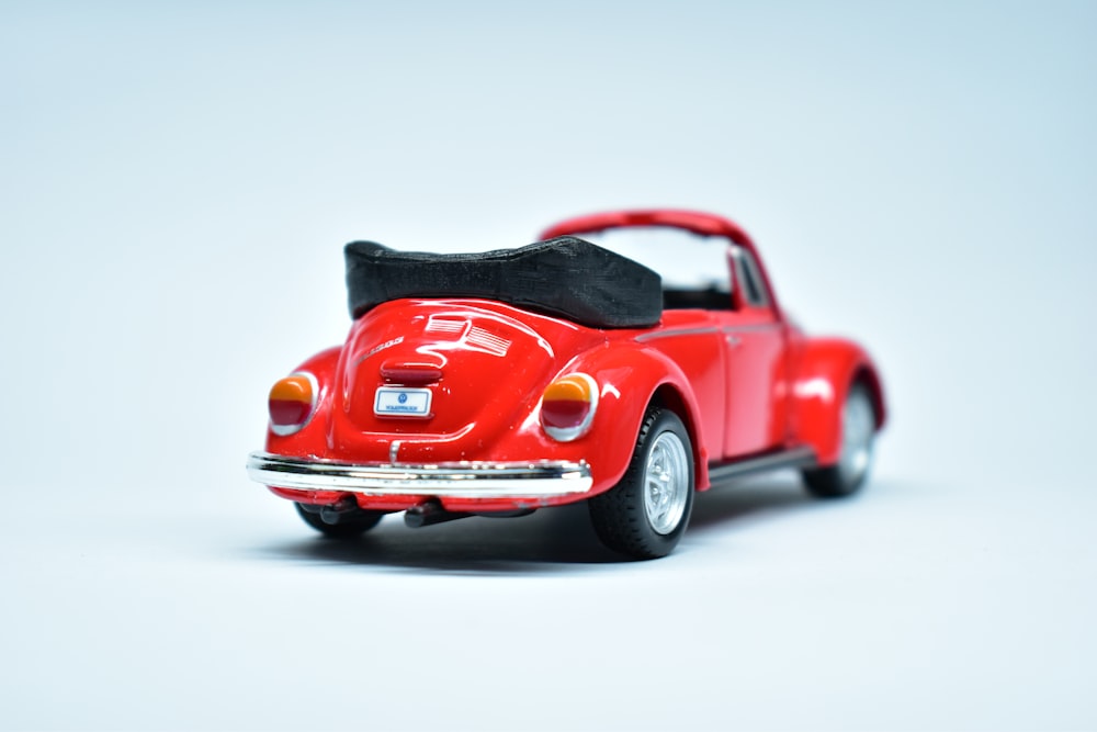 a red toy car with a black seat