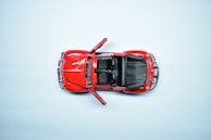 Side profile of a 1:18 scale classic muscle car model with open doors and detailed interior.