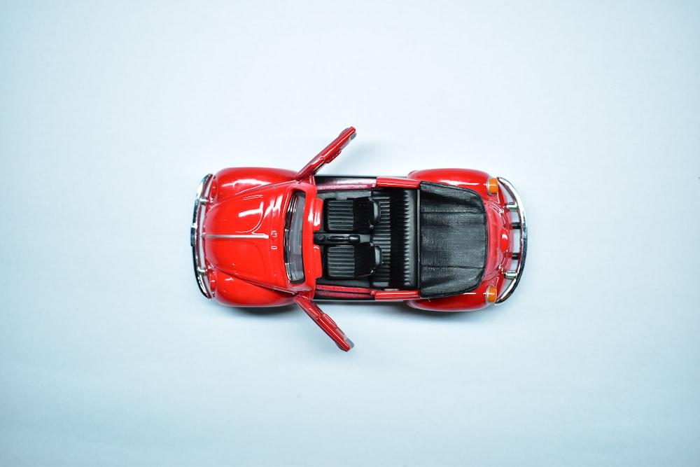 red car scale model on white surface