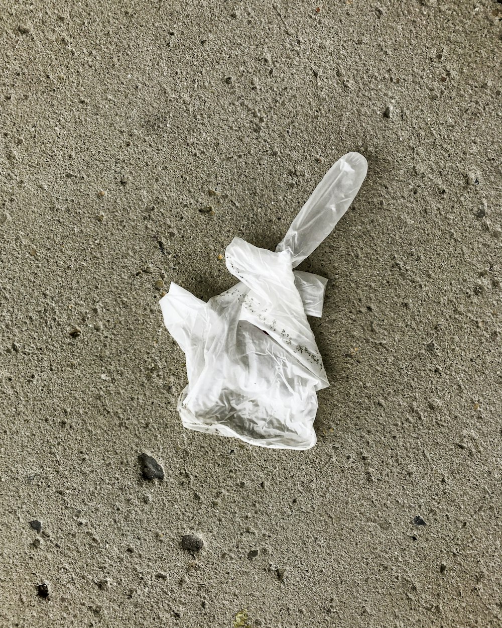 white plastic bag on brown sand