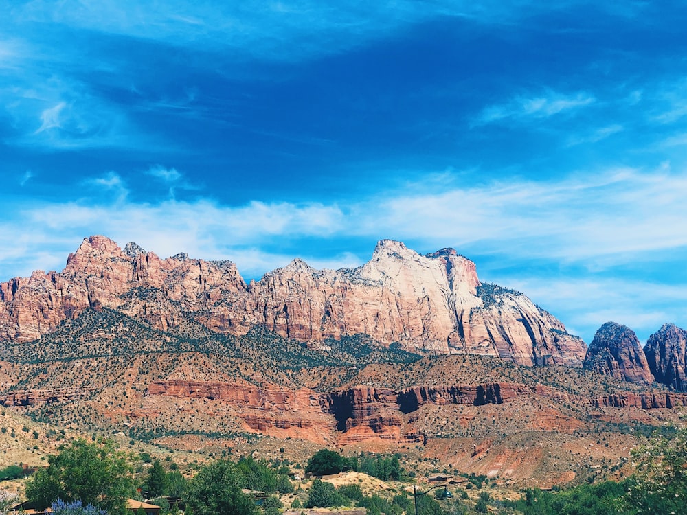 brown rocky mountain under blue sky during daytime