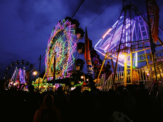 people standing near ferris wheel during night time in Yogyakarta Indonesia