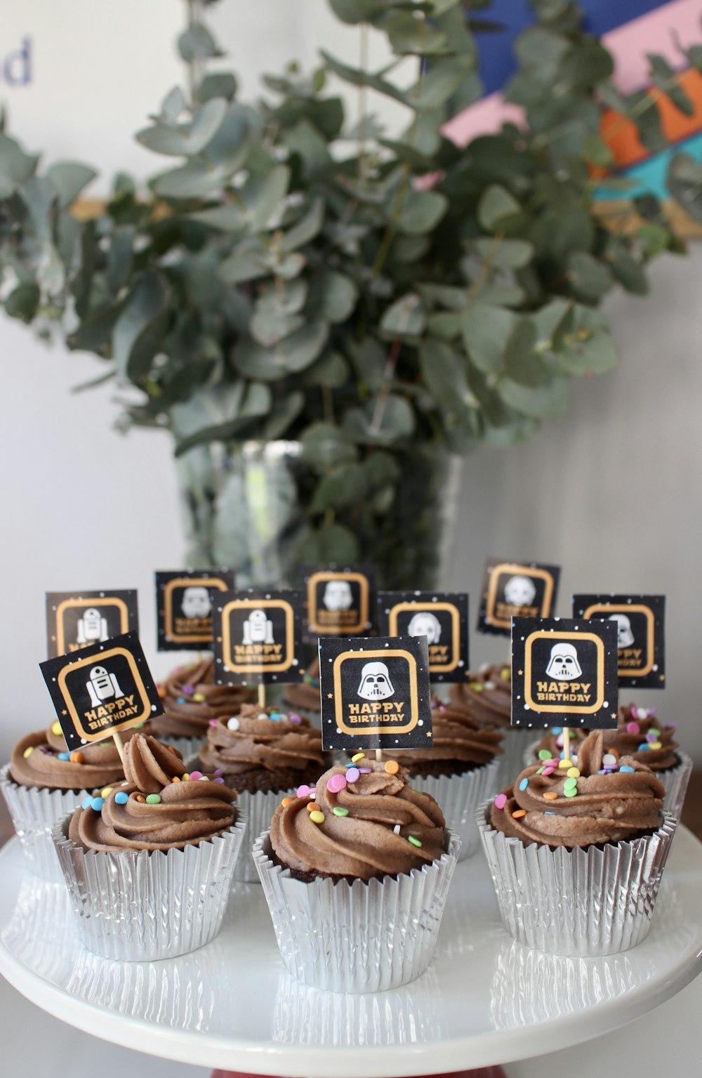 brown and white cupcakes on white wooden table