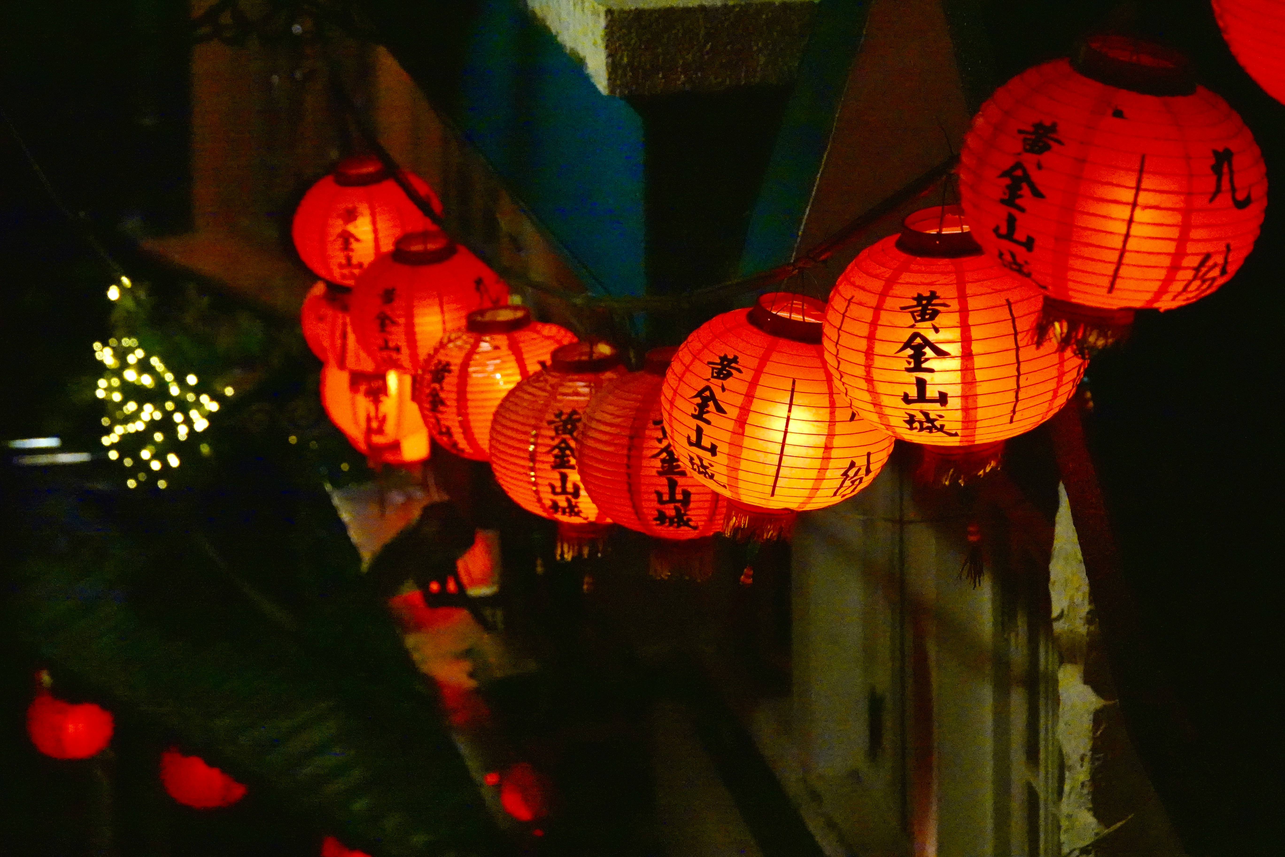 orange paper lantern on blue concrete wall