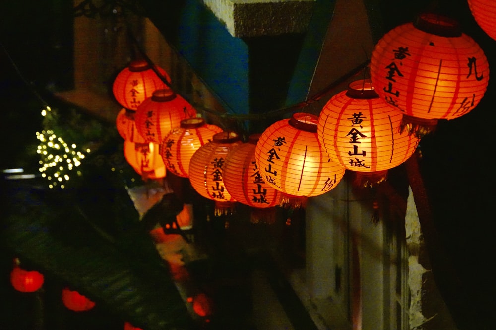 orange paper lantern on blue concrete wall