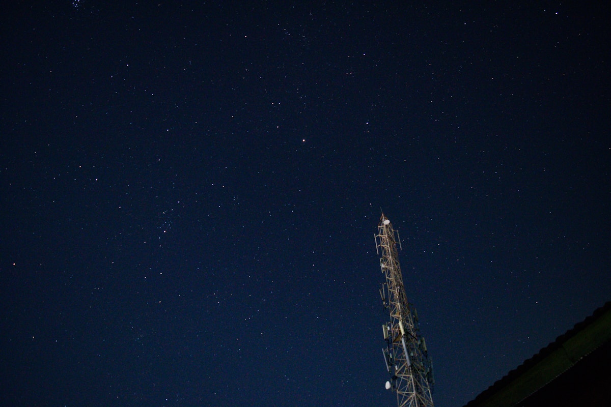 Spacecraft launch structure against deep night sky.