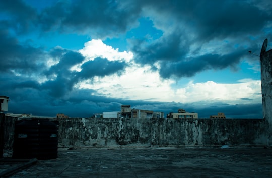 gray concrete building under blue sky and white clouds during daytime in Ahmedabad India