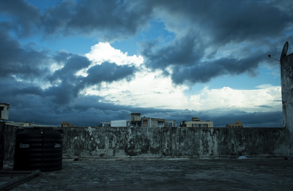 gray concrete building under blue sky and white clouds during daytime