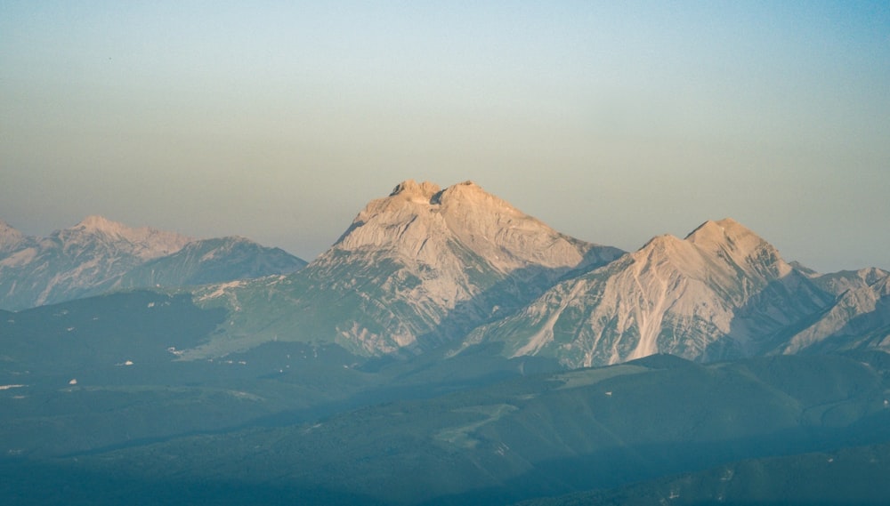 brown and white mountains under blue sky during daytime