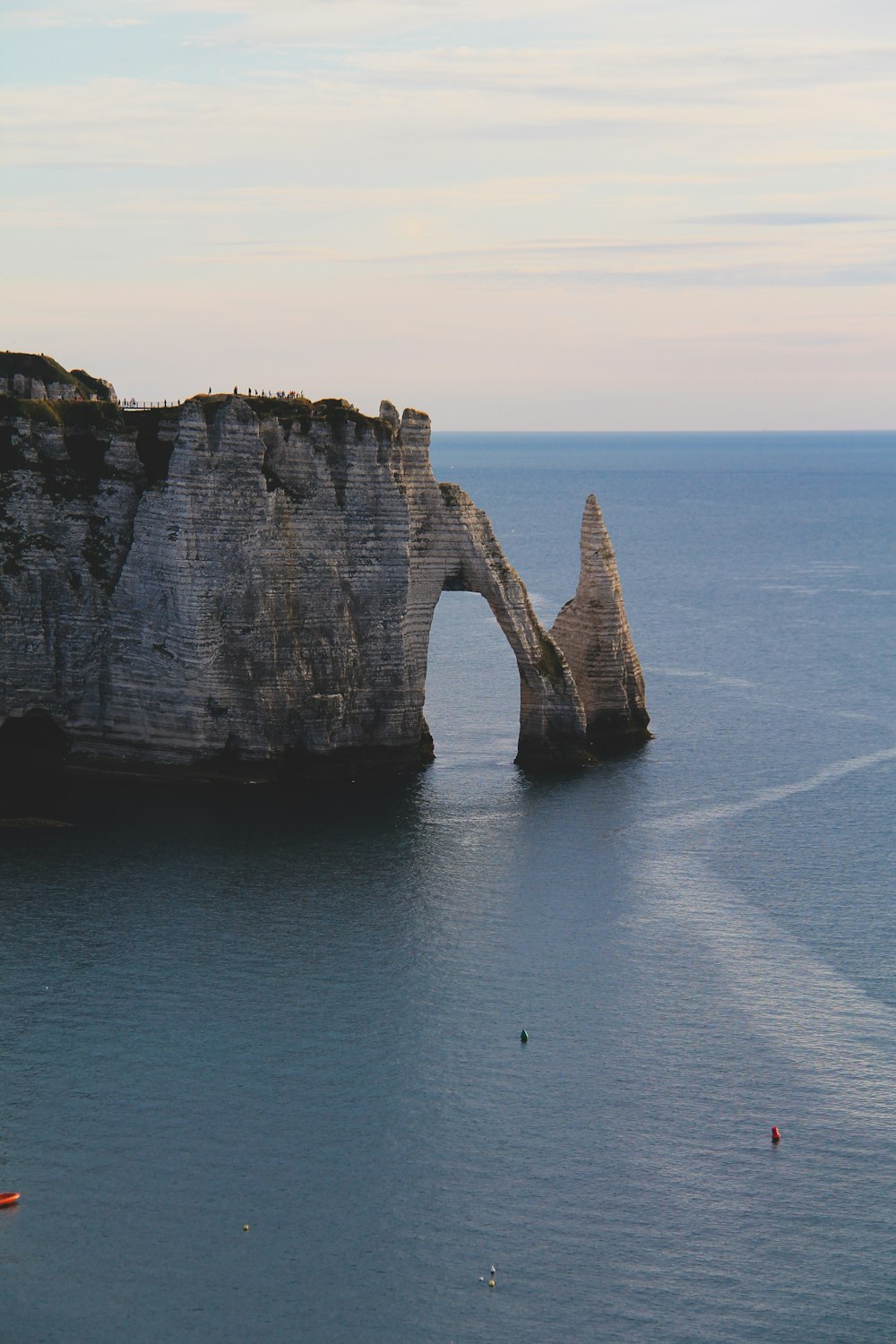 brown rock formation on blue sea during daytime