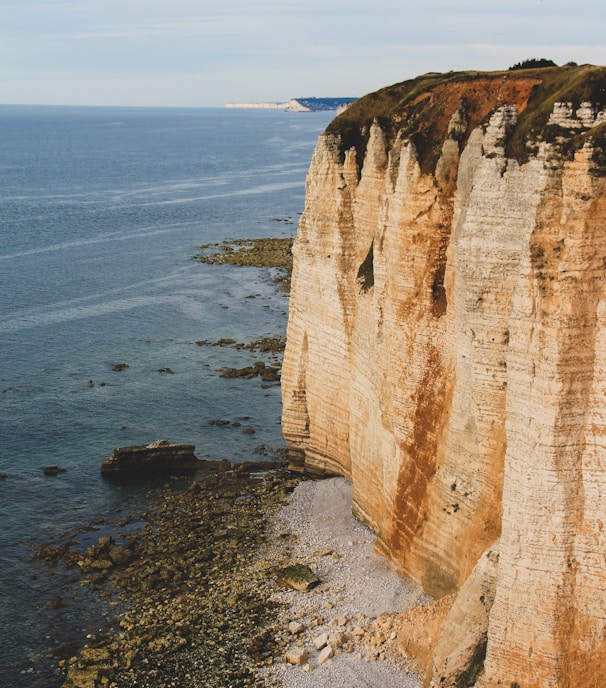 brown rock formation on sea shore during daytime