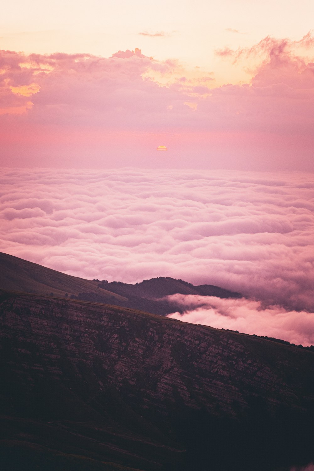 white clouds over mountains during daytime