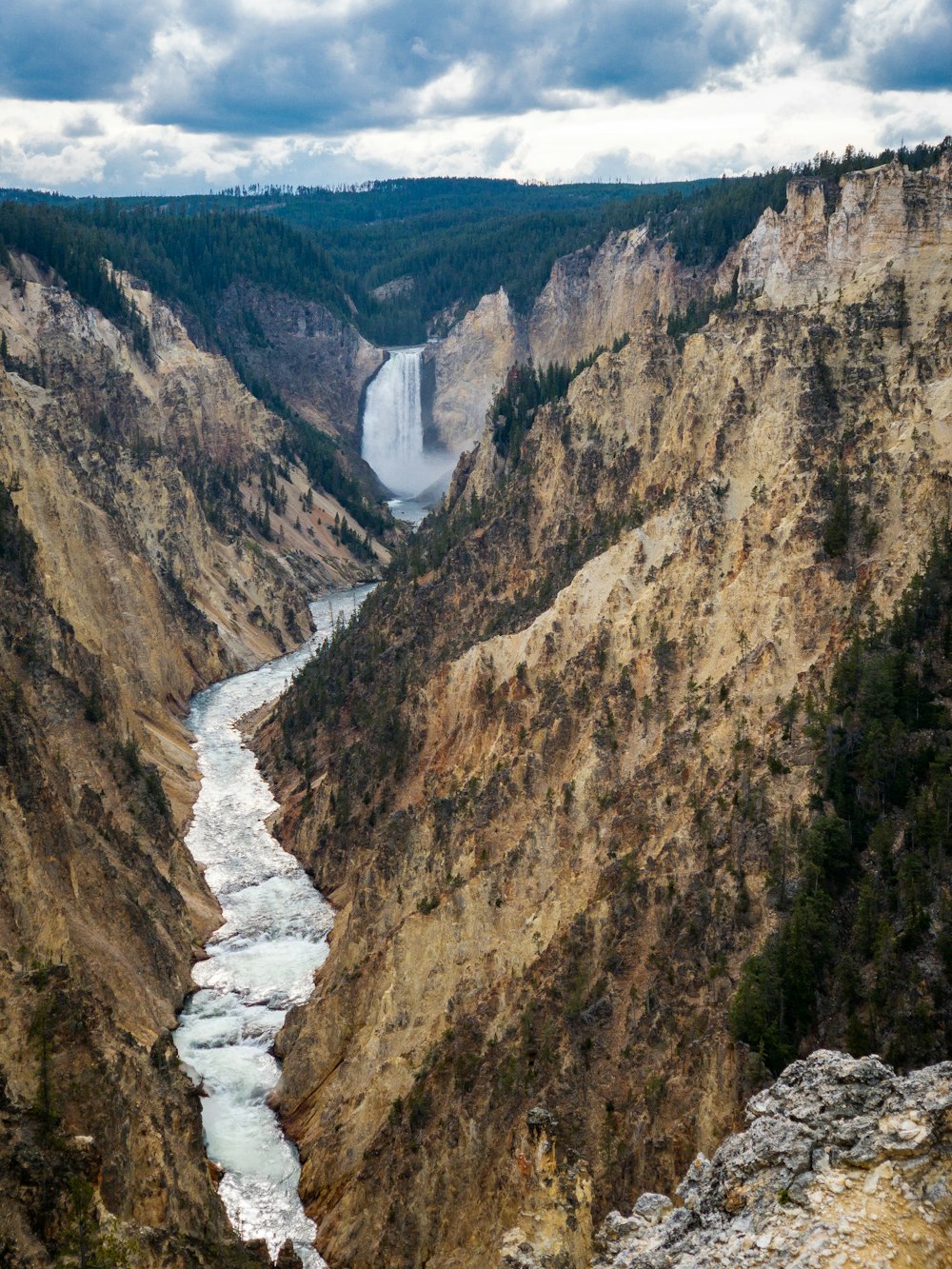 river between brown and green mountains during daytime