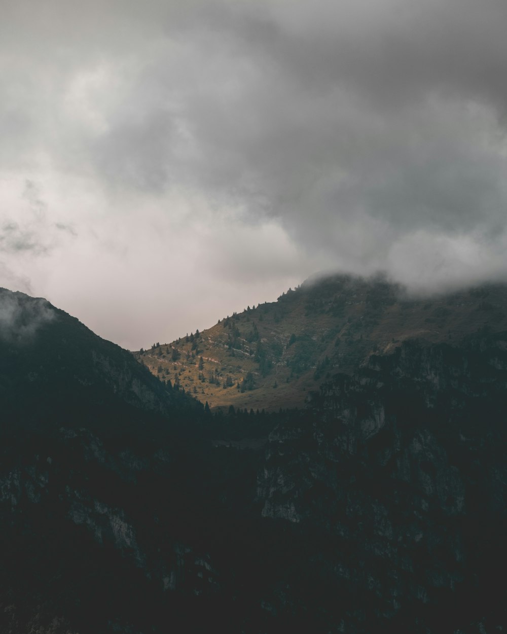 green and black mountains under white clouds