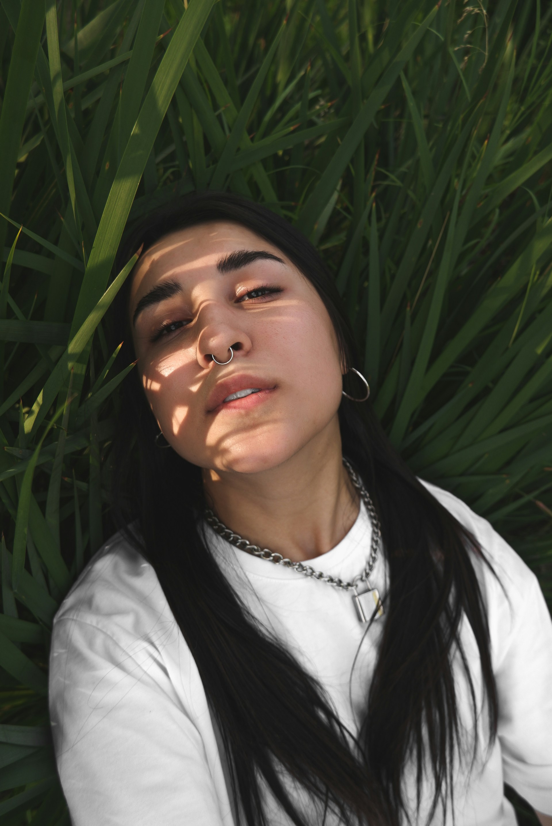 woman in white shirt with silver earrings