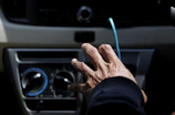 Close-up of a technician tuning acceleration and brake settings on a Club Car dashboard.