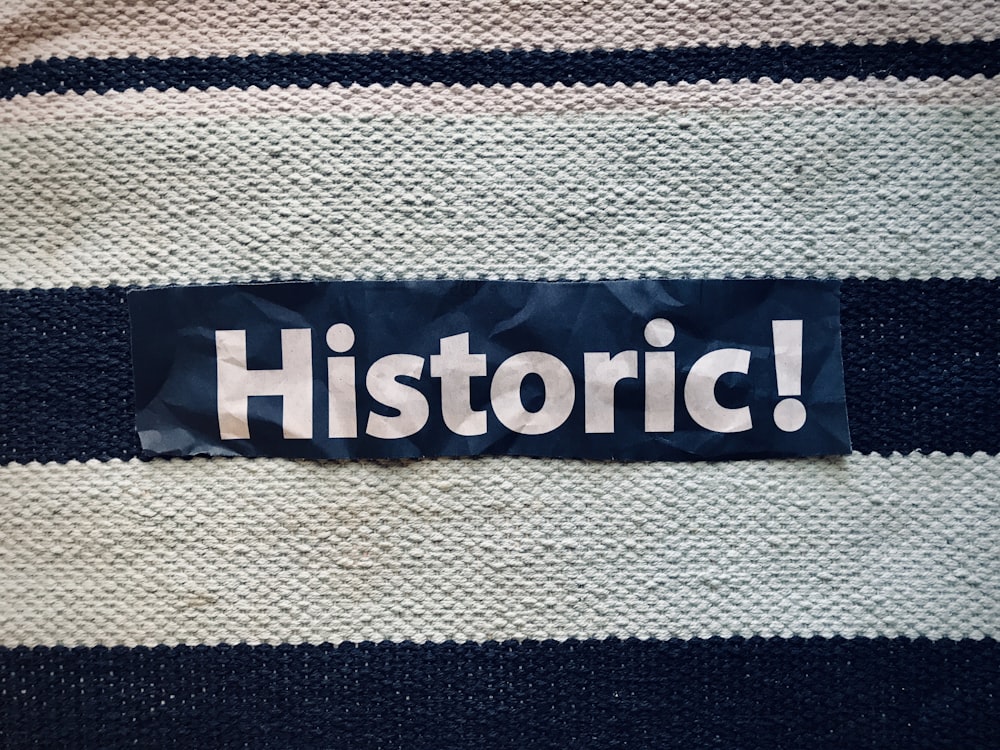 a blue and white striped sweater with the word historic on it
