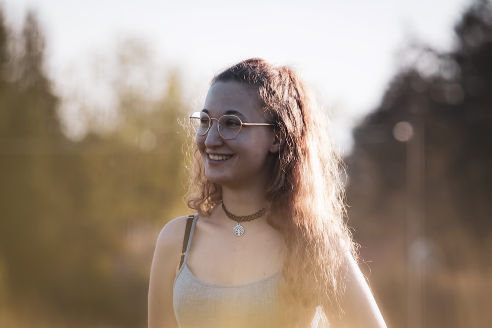 woman in white tank top wearing eyeglasses