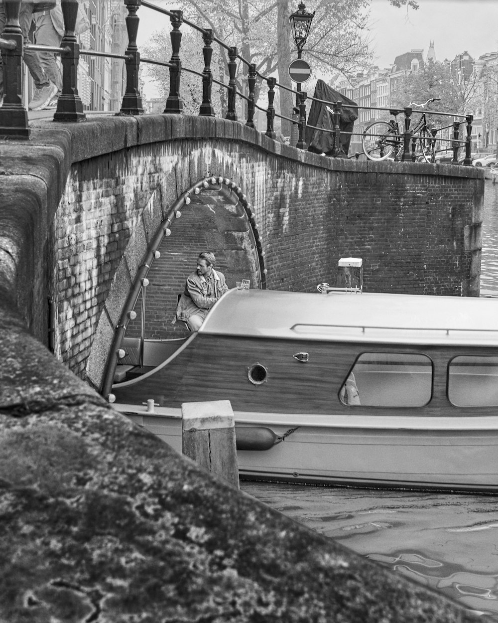 grayscale photo of a boat on a dock