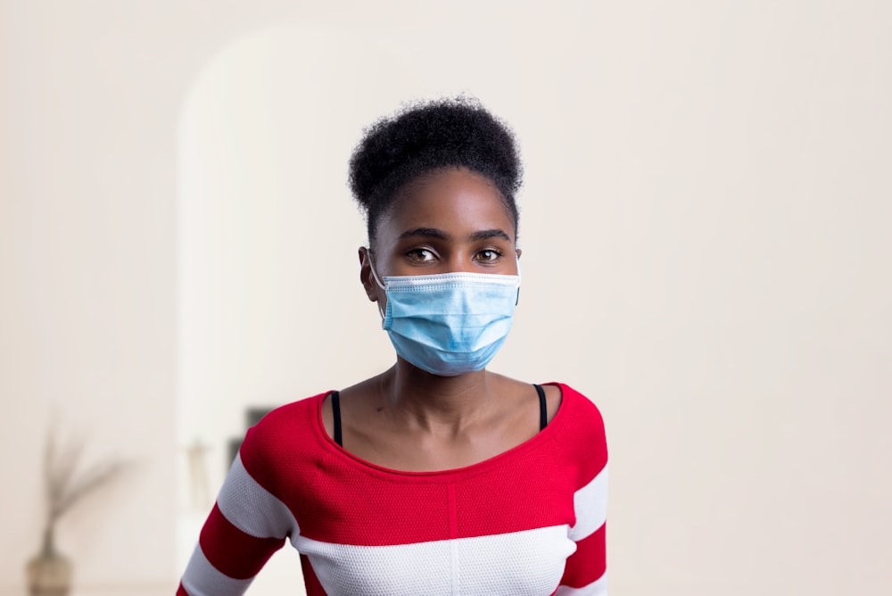 woman in white red and black striped crew neck long sleeve shirt with face mask