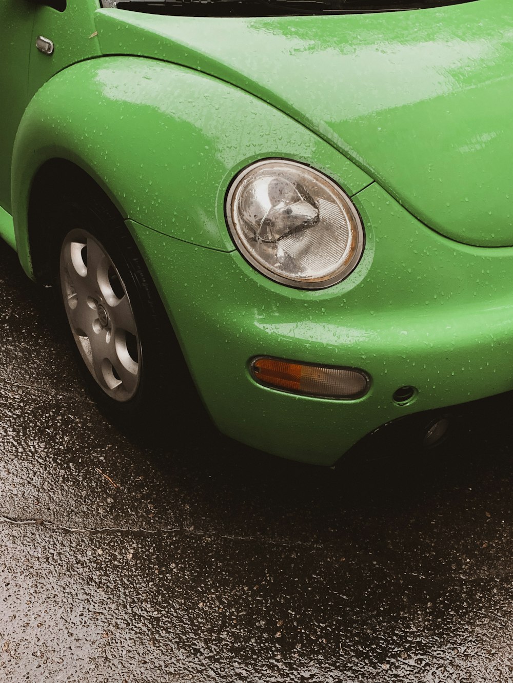 green car on gray asphalt road