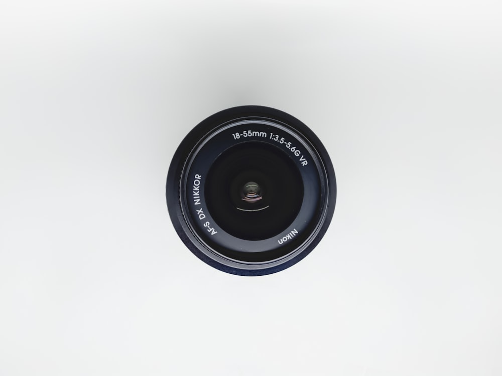 black camera lens on white surface