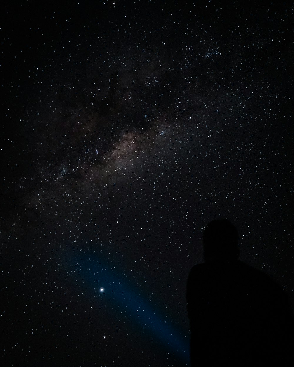 silhouette of man under starry night