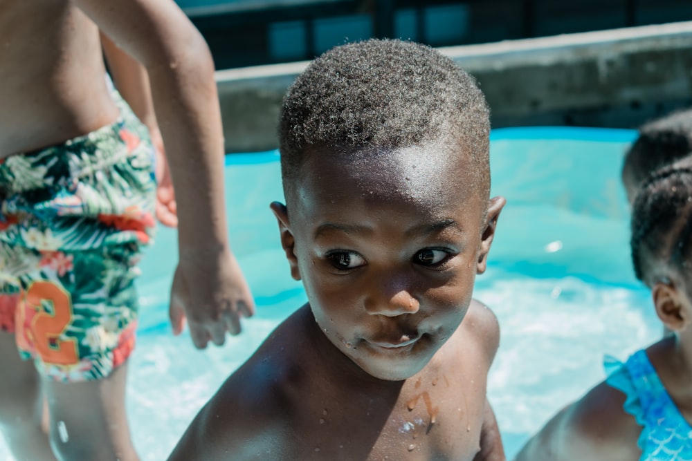 boy in swimming pool during daytime