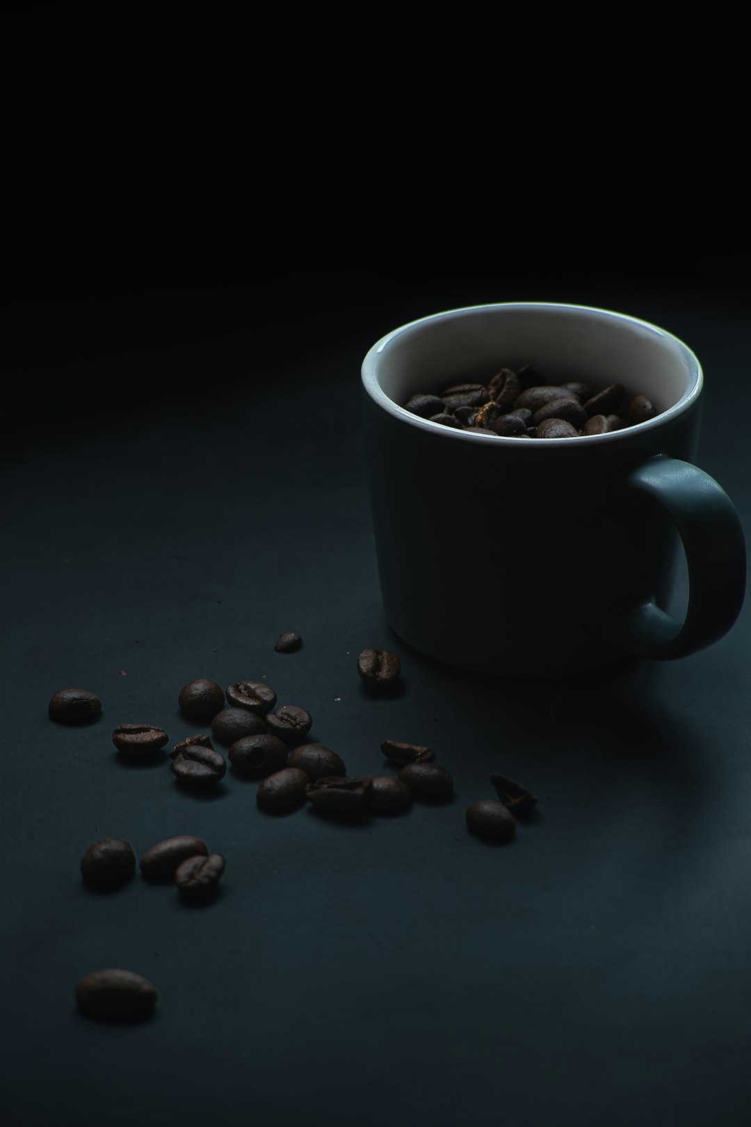 white ceramic mug with coffee beans