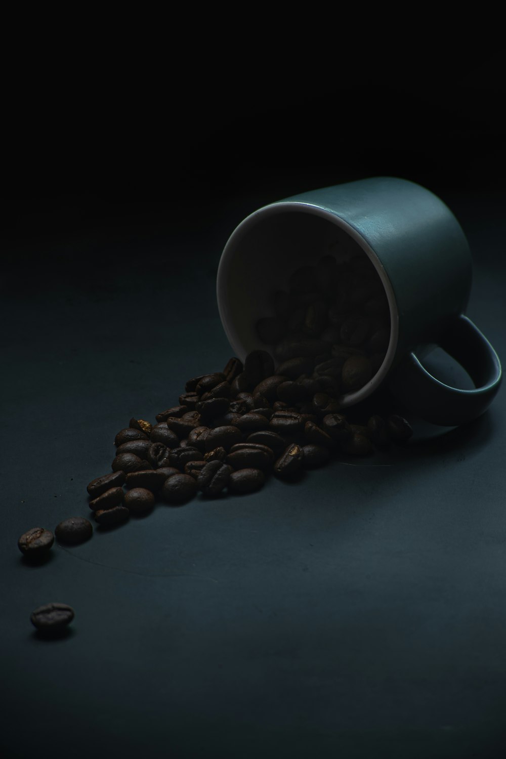 white ceramic mug on black table