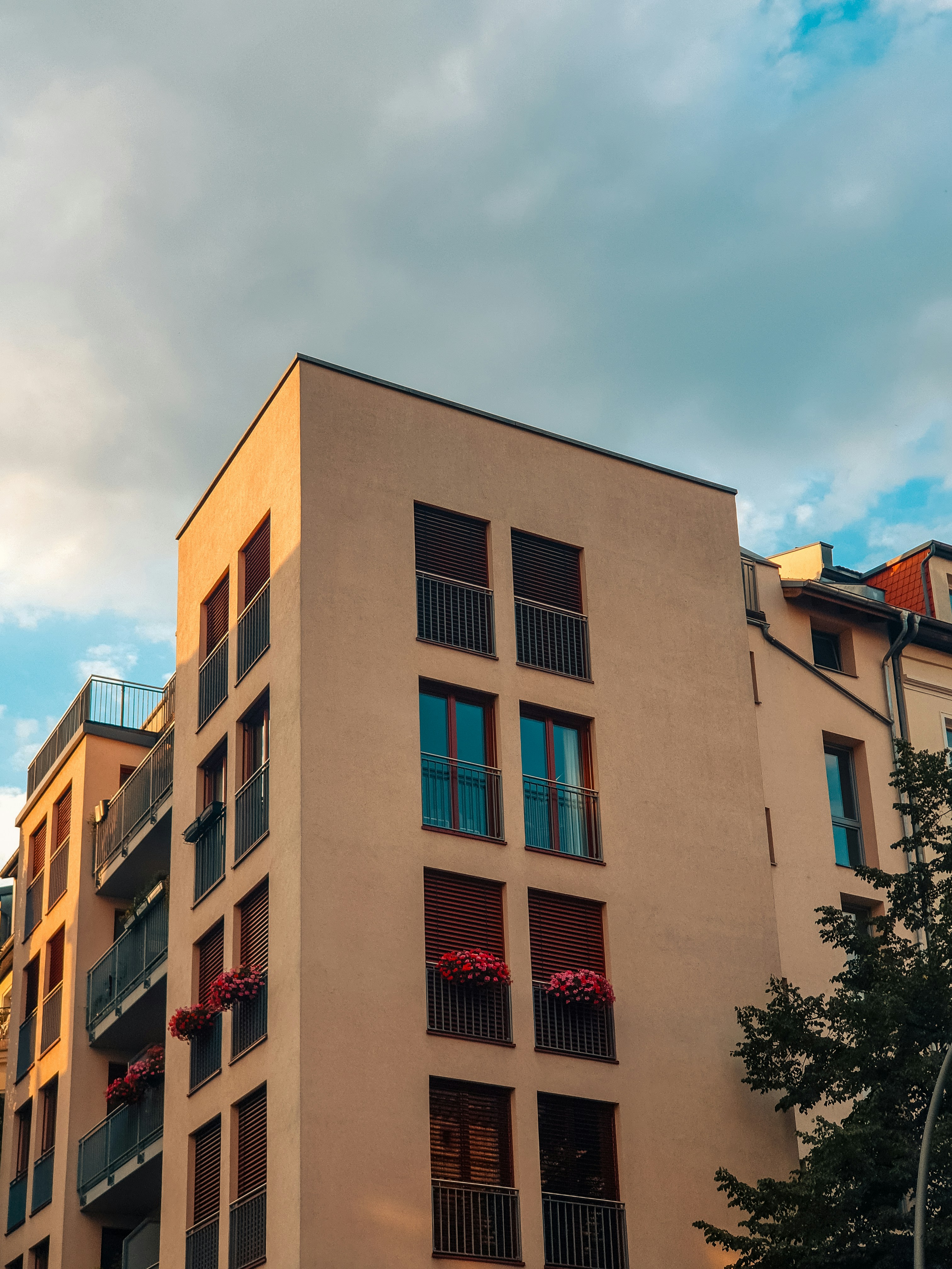 A sleek, modern apartment building in Mogadishu bathed in warm afternoon light.