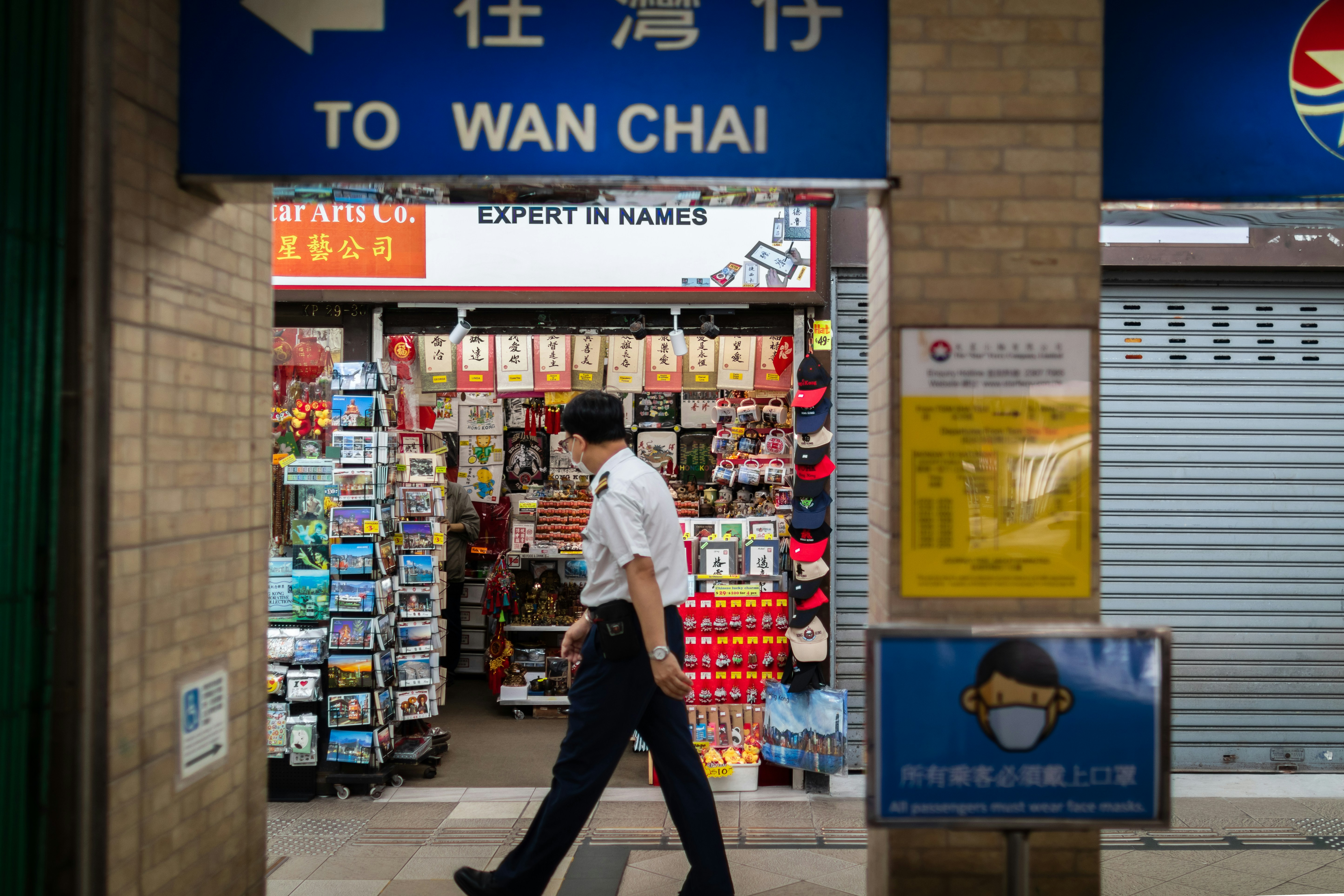 woman in black jacket standing near shopping cart