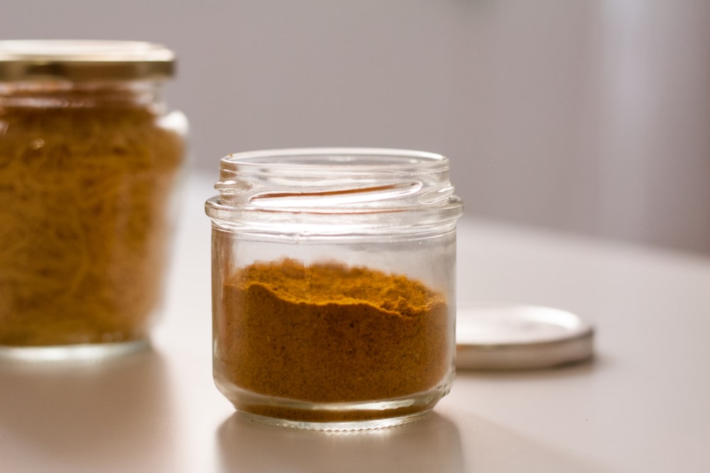 clear glass jar with brown powder