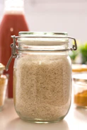 clear glass jar with brown powder inside