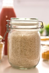 clear glass jar with brown powder inside