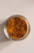 brown powder in clear glass container