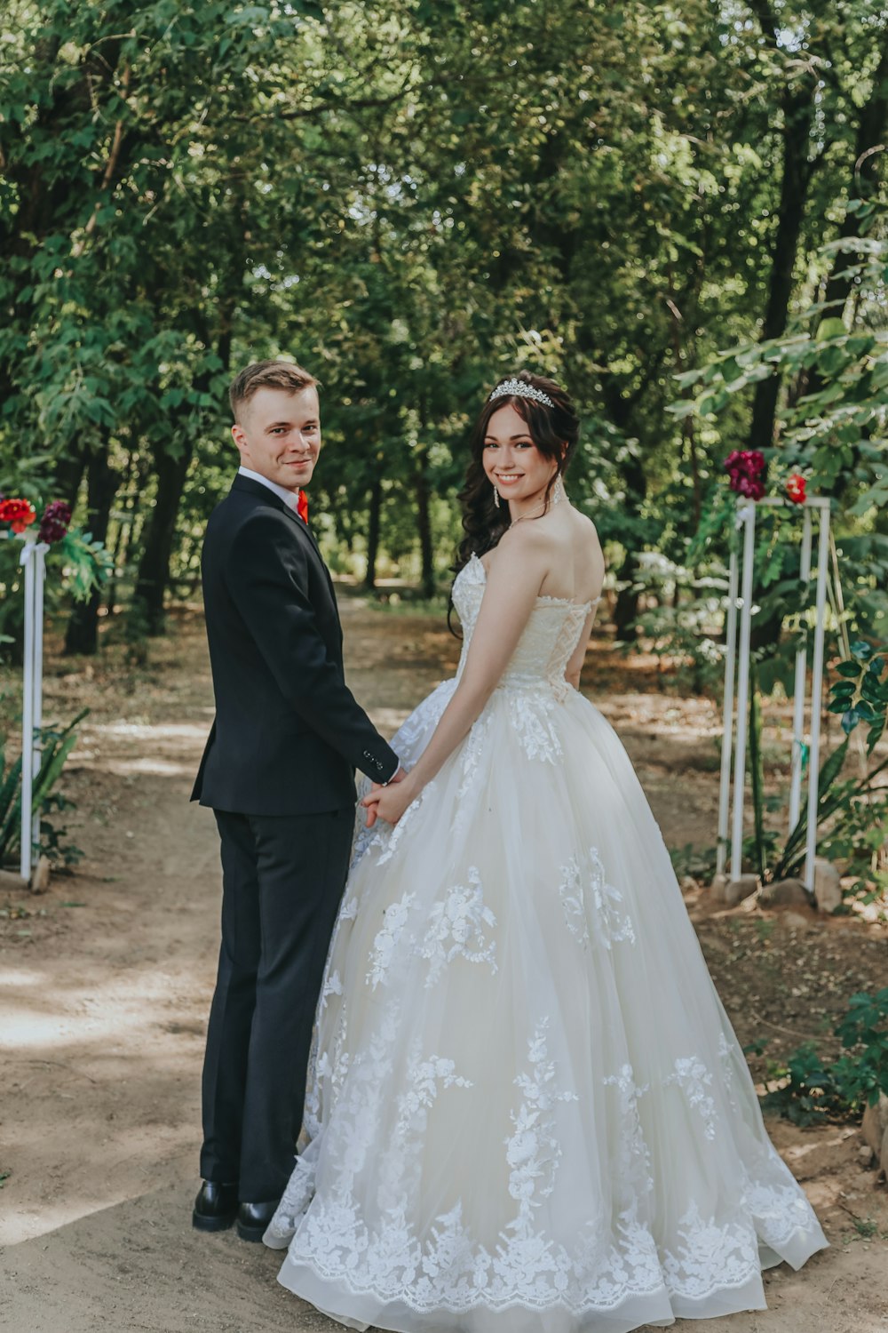 woman in white wedding dress and man in black suit
