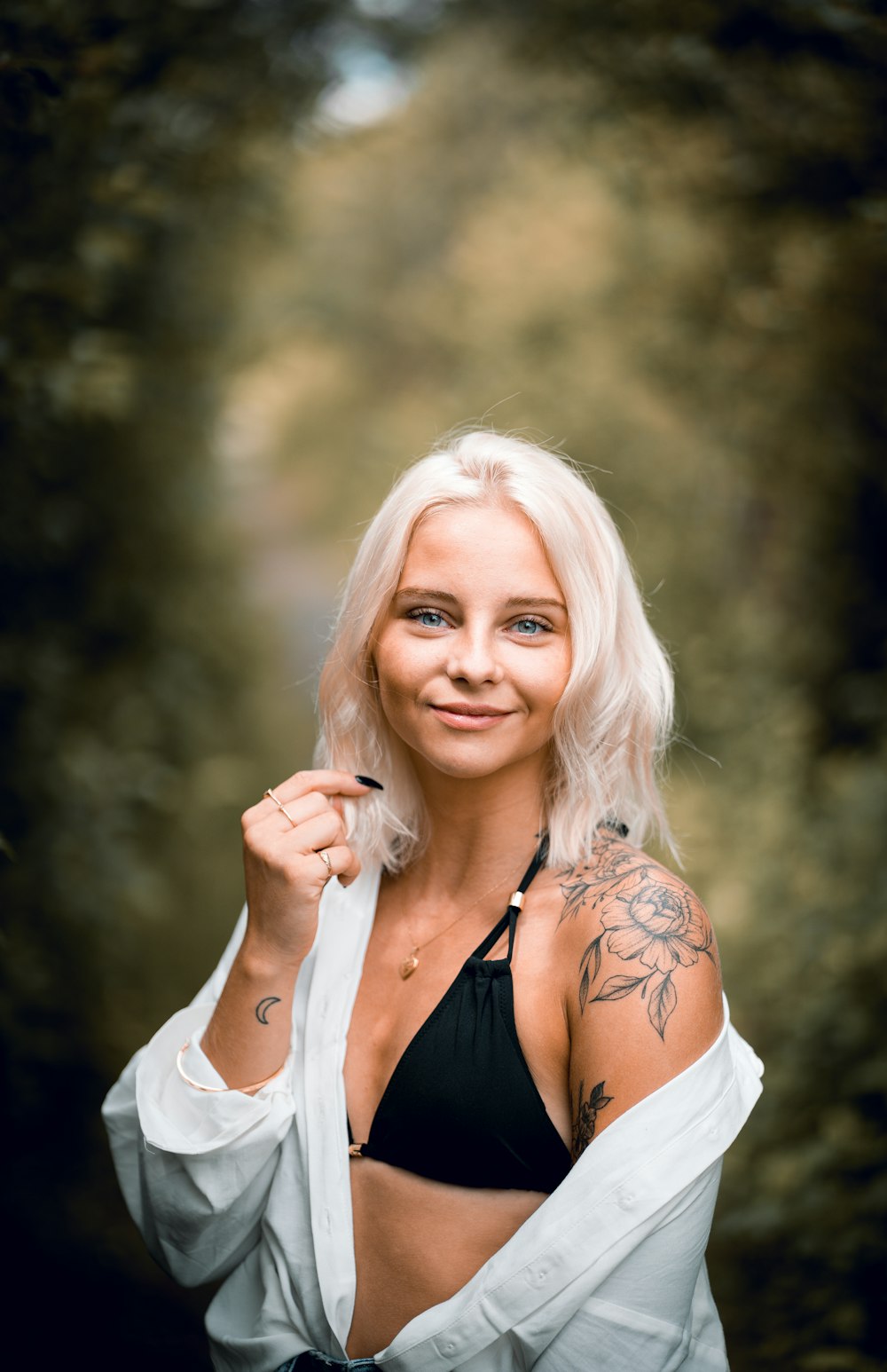 woman in black tank top smiling