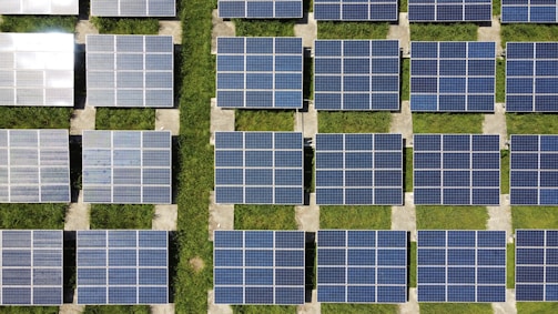 Rows of solar modules aligned in a sunlit field ready for installation
