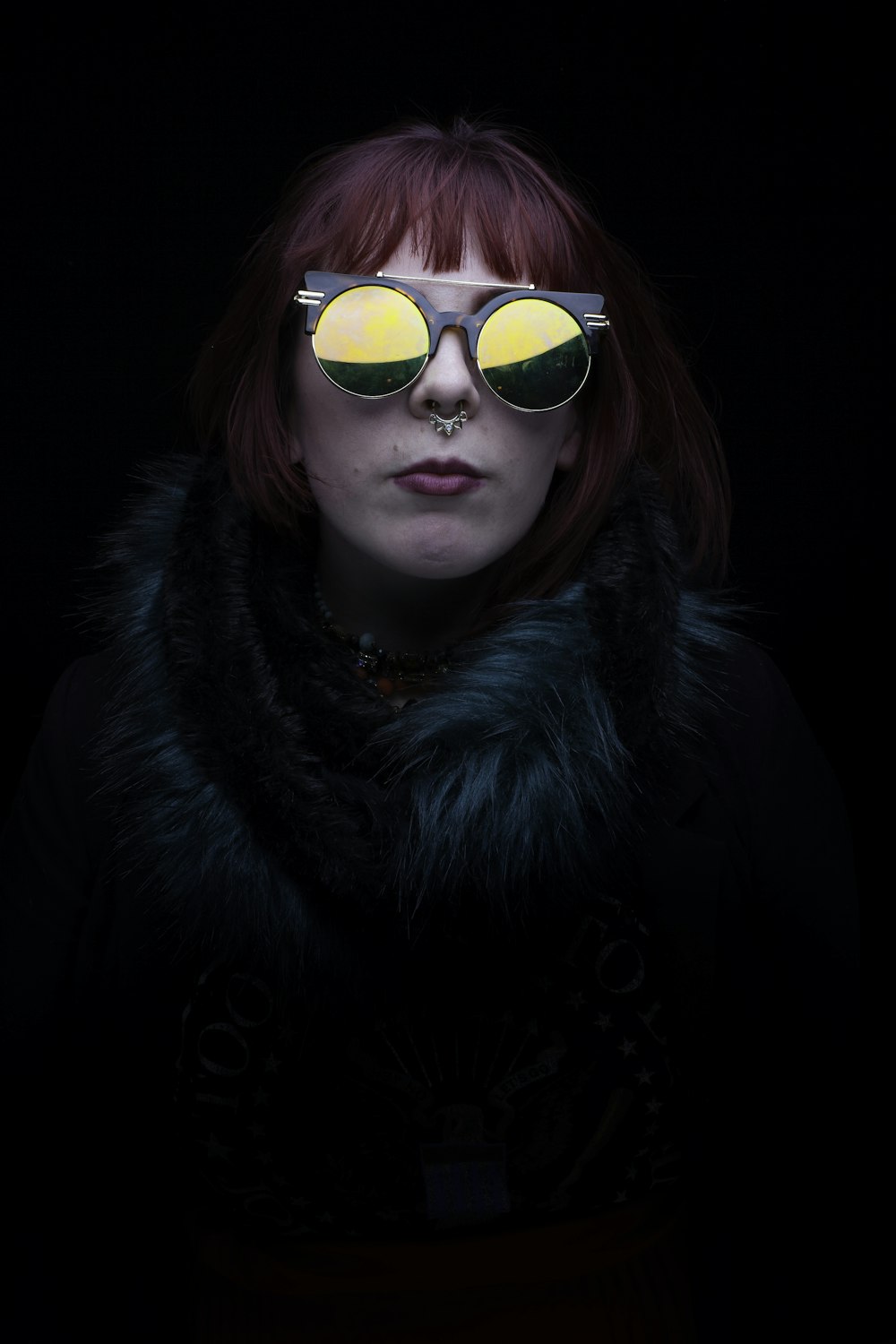 woman in black fur coat wearing sunglasses