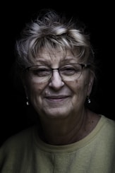 woman in green crew neck shirt wearing eyeglasses