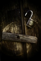 gold padlock on brown wooden surface