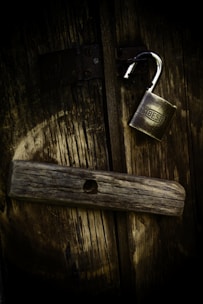 gold padlock on brown wooden surface