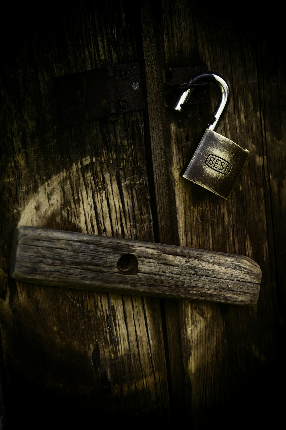 gold padlock on brown wooden surface