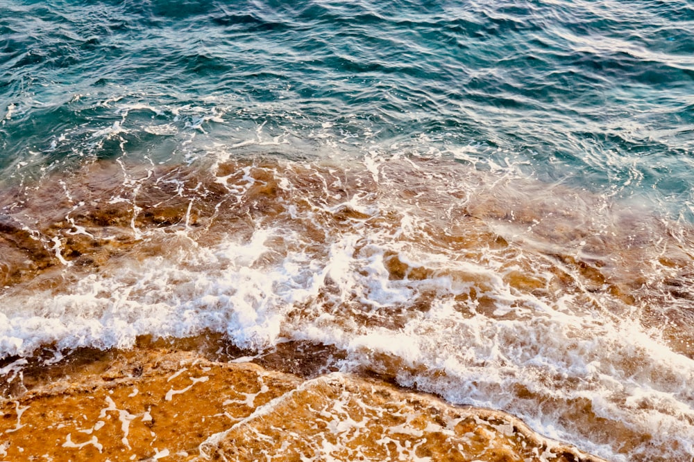 water waves on brown sand