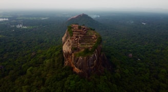 brown rock formation under white sky during daytime