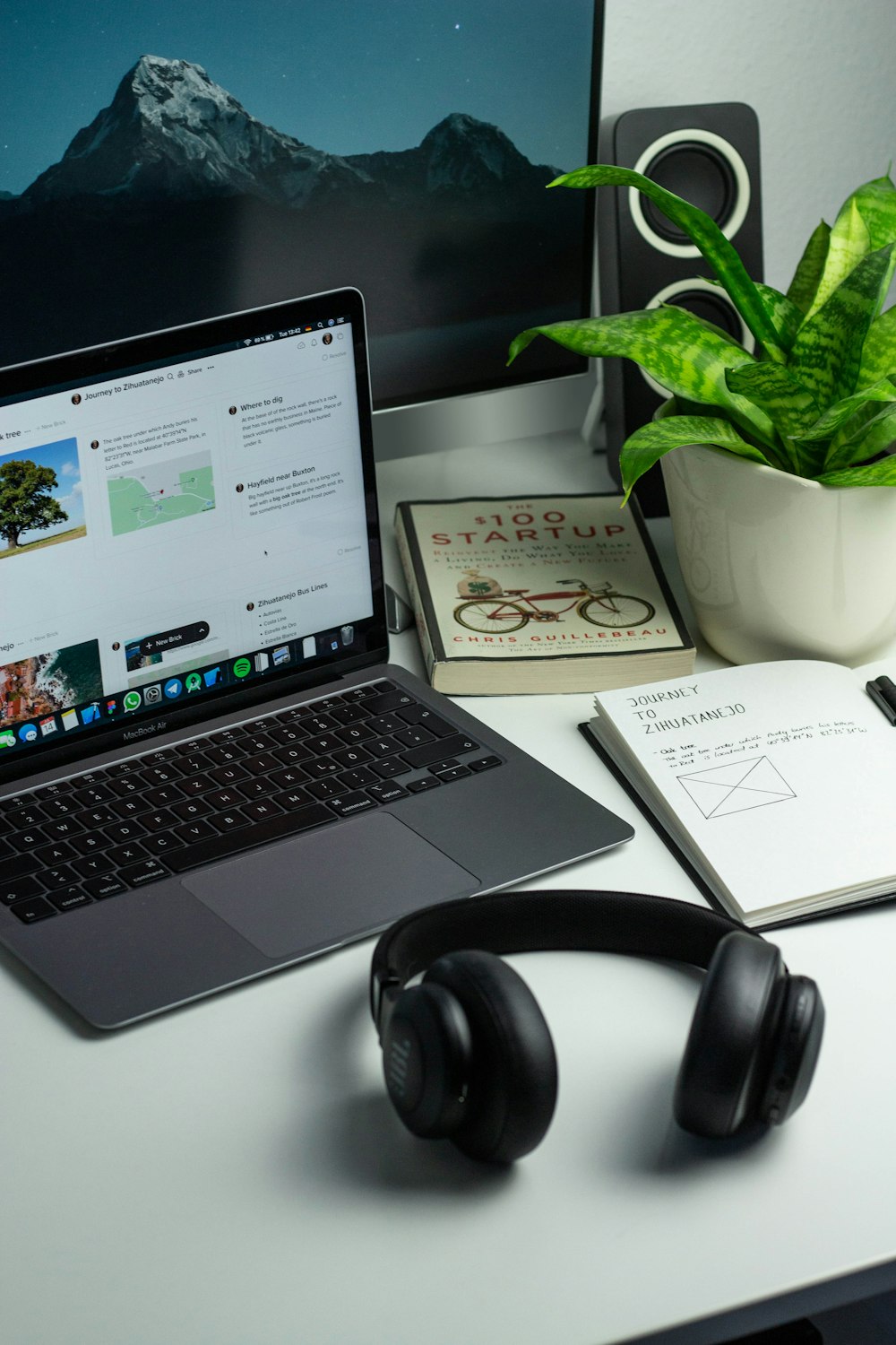 black and silver laptop computer beside black headphones